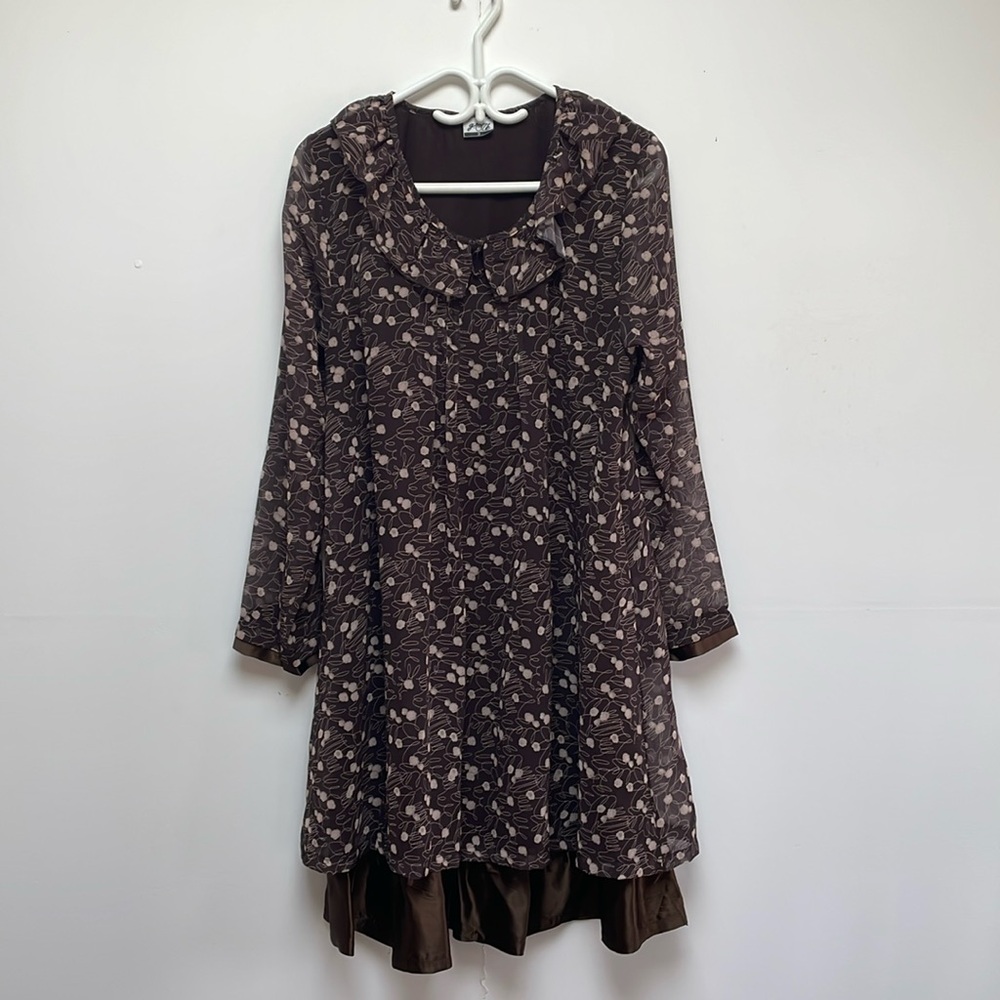 Loose fitting sheer feminine dress with satin flounce.